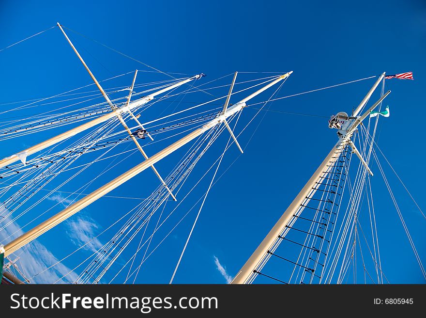 Ship masts against the blue sky