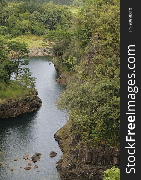 Aerial view of a river running through a lush green forest. Aerial view of a river running through a lush green forest