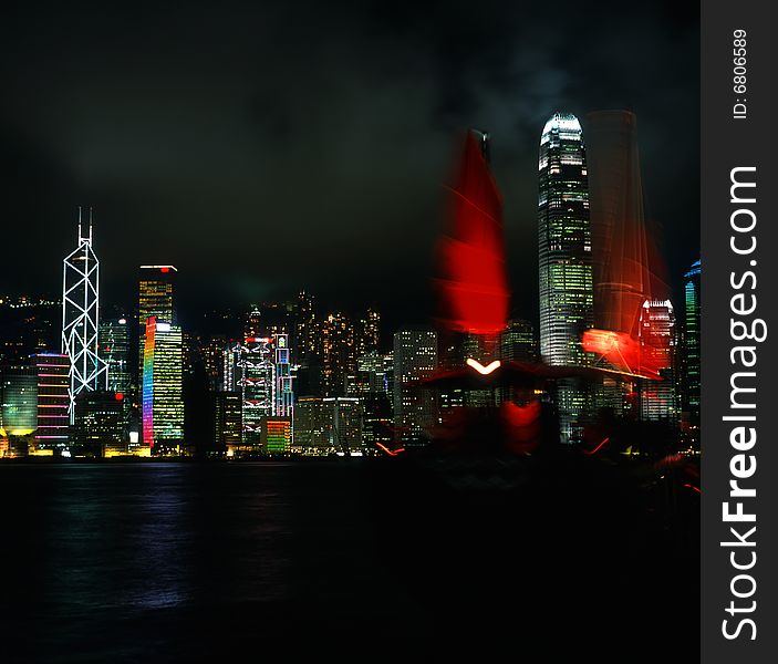 A red sail in the Victoria Bay, Hong Kong