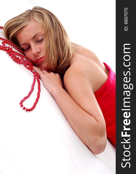 Blond girl with red necklace on white background. Blond girl with red necklace on white background