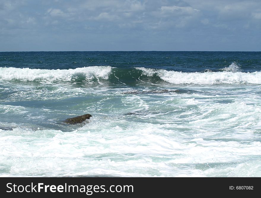 Waves flowing in and over the rocks. Waves flowing in and over the rocks.