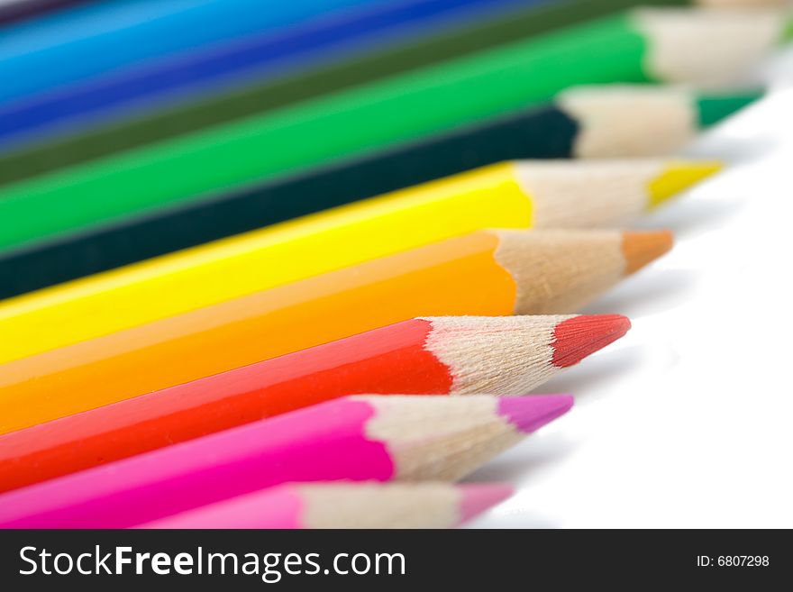 Line of colorful pencils isolated on white