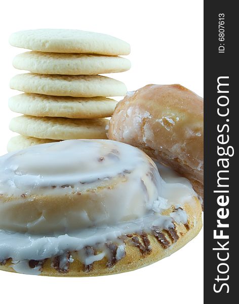 Sugar cookies, cinnamon roll, and donut isolated on white. Sugar cookies, cinnamon roll, and donut isolated on white