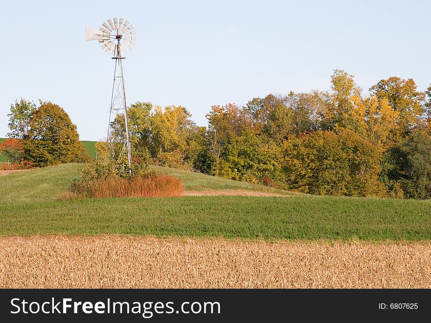 Windmill atop a field in the autumn months