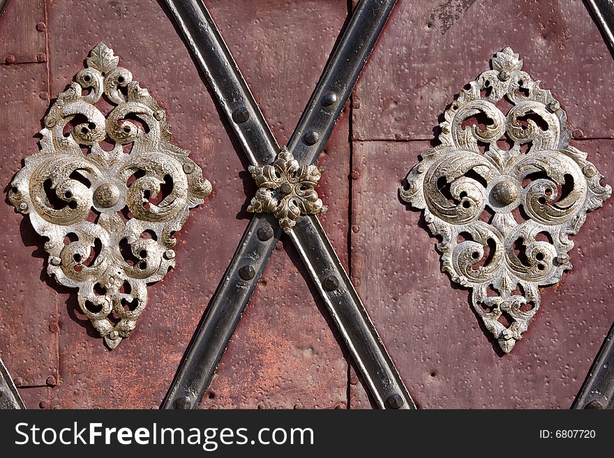 Decoration detail of old metal iron entrance door in Prague Little quarter. Decoration detail of old metal iron entrance door in Prague Little quarter.