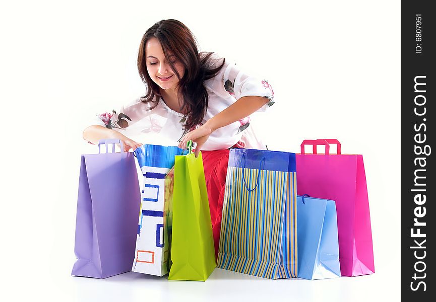 Shopping girl look over shopping bags,isolated on white background. Shopping girl look over shopping bags,isolated on white background