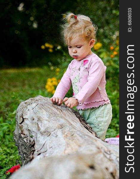 An image of little baby-girl playing outdoor. An image of little baby-girl playing outdoor