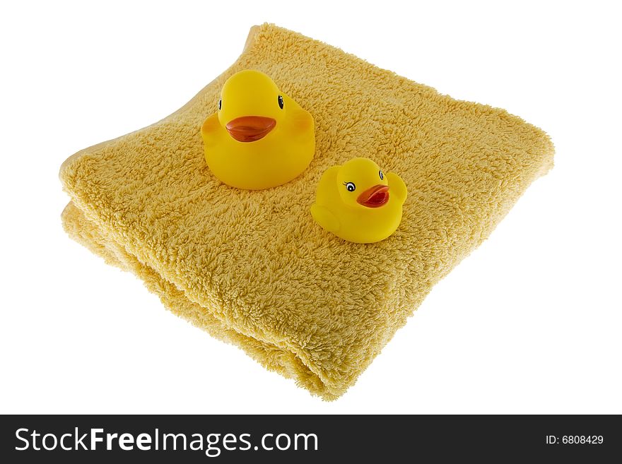 Rubber duck sits on towel, toys made of plastic for taking a bath