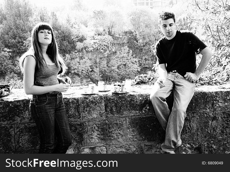 Vedran i Emina standing drinking cofee and smoking cigarets. Vedran i Emina standing drinking cofee and smoking cigarets