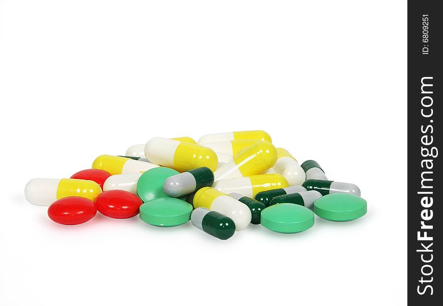 Tablets and capsules with a medicine on a white background