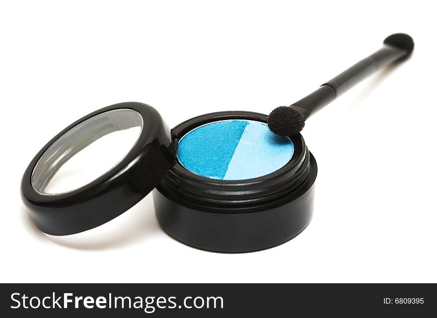 Blue make-up eyeshadows and cosmetic brush