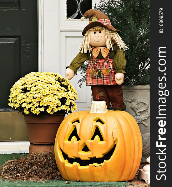 Smiling scarecrow and pumpkin