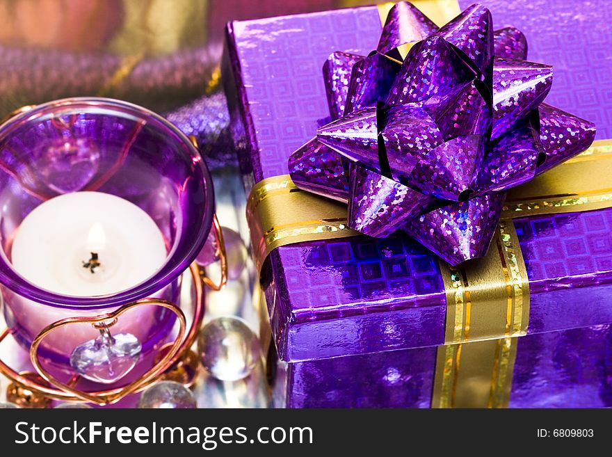 Violet candle with heart and gift box