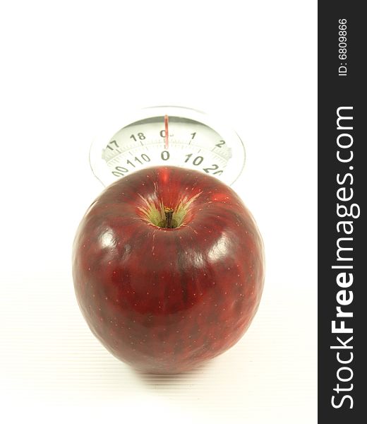 Apple on scales on isolated background. Apple on scales on isolated background.