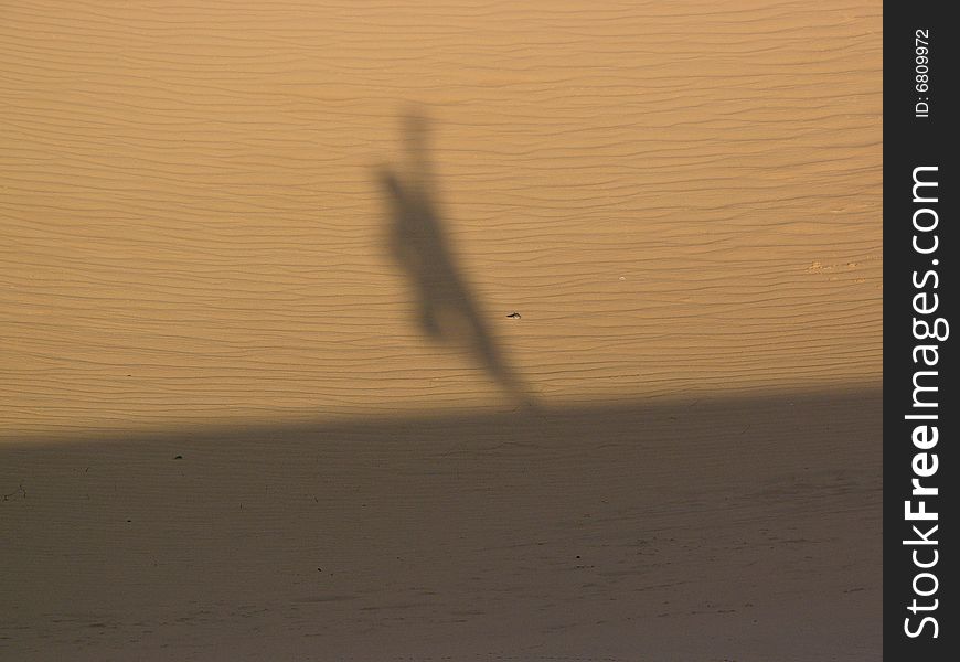 Shadow of a gongfu pose on the desert. Shadow of a gongfu pose on the desert.