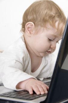 Curious Baby Playing With Laptop Royalty Free Stock Photos