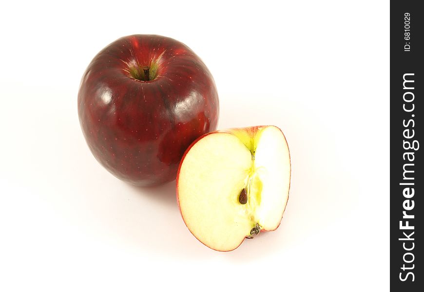 Red apple with one cut to show the seed inside; on isolated background. Red apple with one cut to show the seed inside; on isolated background.