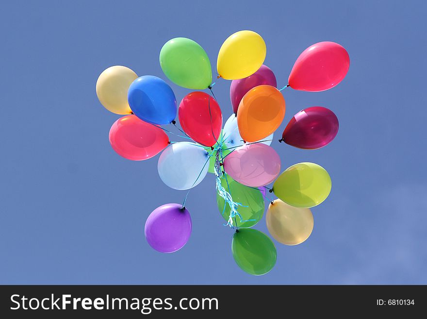 Multi colored balloons in blue sky
