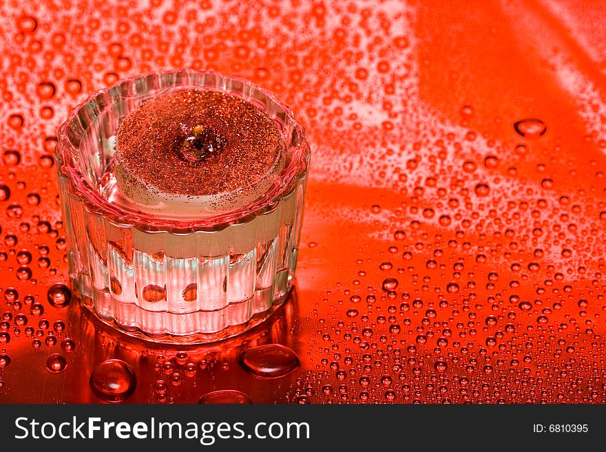 Red candle and water drops