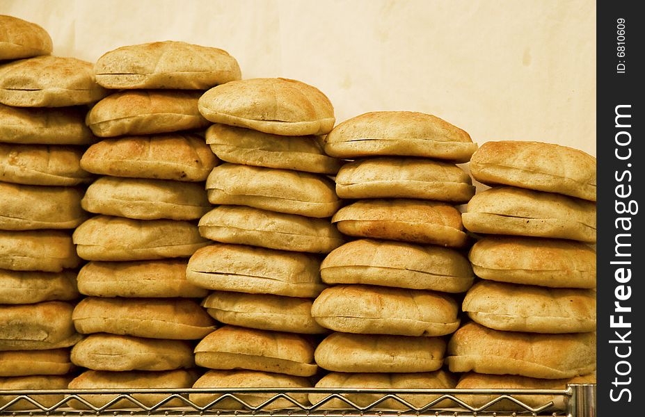 Stacks of fresh baked bread at a bakery. Stacks of fresh baked bread at a bakery