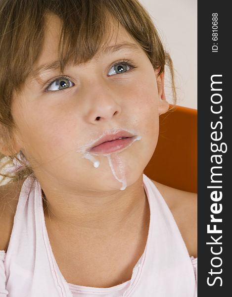 Little girl with milk mustache  looking upward