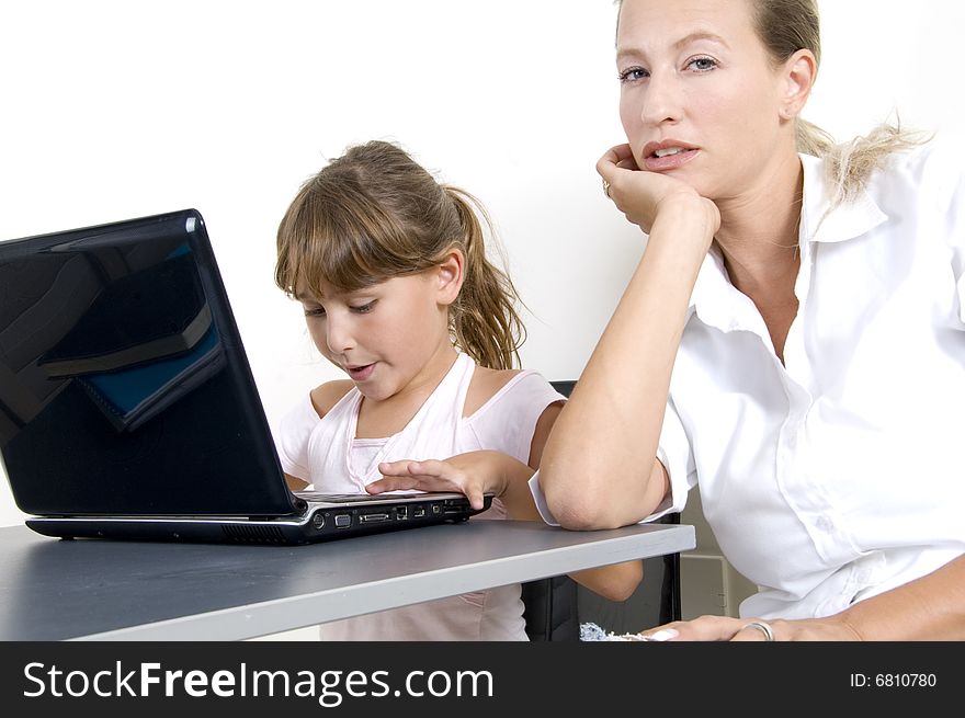 Mother and daughter working on laptop