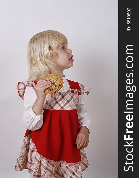 Sweet girl eating chocolate chip cookie. Sweet girl eating chocolate chip cookie