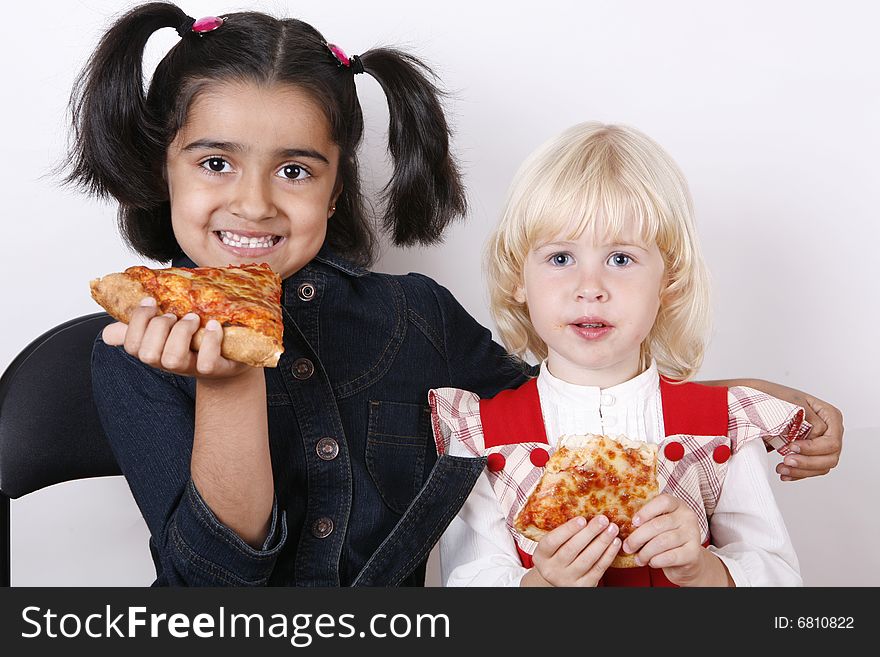 Sweet girls eating cheese pizza slice. Sweet girls eating cheese pizza slice