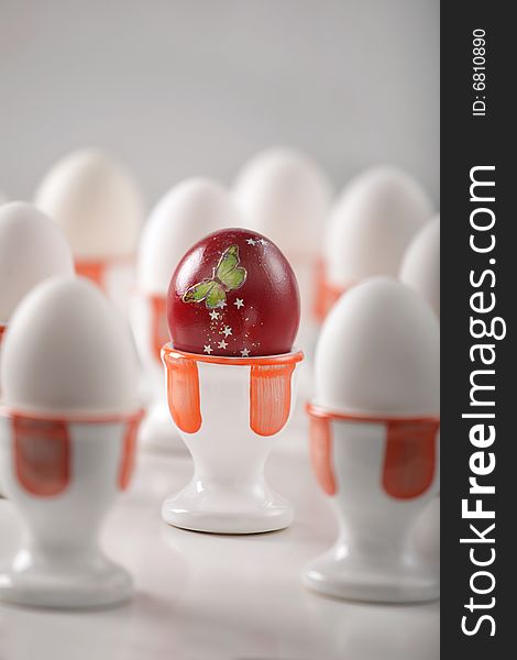 Red egg with dozen white eggs