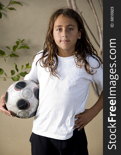 Tired boy standing with soccer ball. Tired boy standing with soccer ball