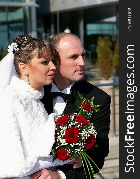 Groom holding the bride in wedding dress