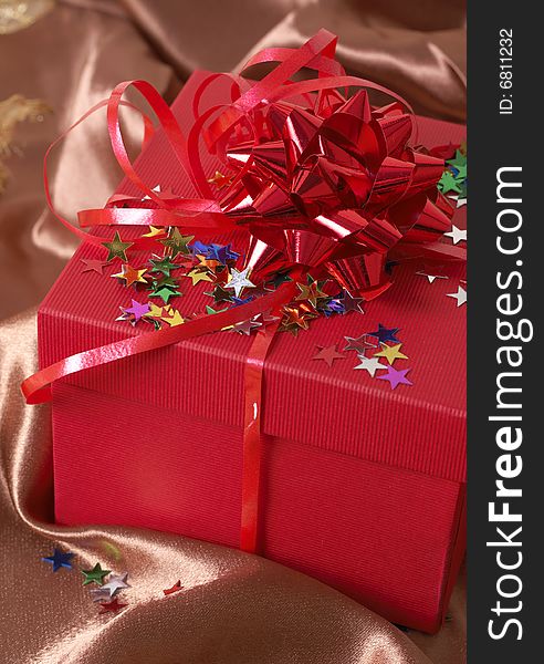 Red gift box with bows and stars