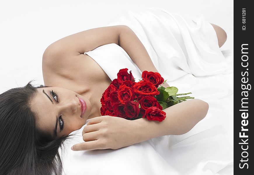 Asian lady in bed with red roses