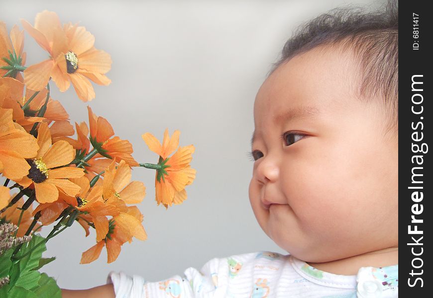 A cute baby and flower. A cute baby and flower