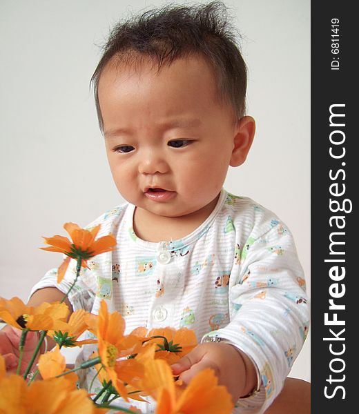 A cute baby and flower. A cute baby and flower