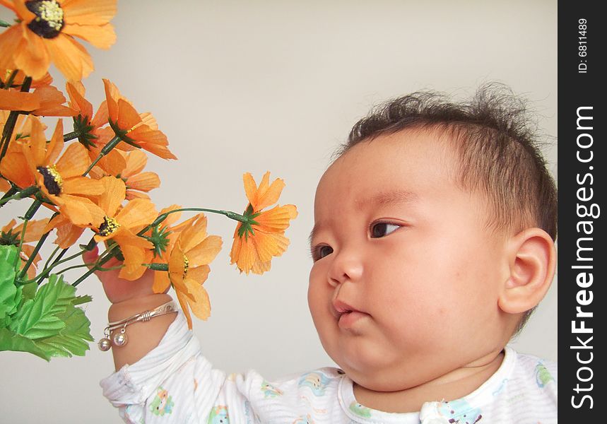A cute baby and flower with white background. A cute baby and flower with white background