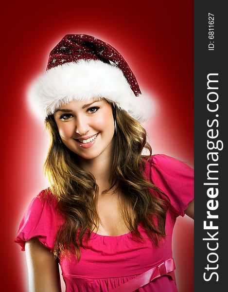 Winter portrait of a beautiful young smiling woman with a christmas cap. Winter portrait of a beautiful young smiling woman with a christmas cap