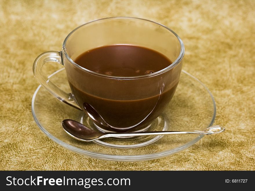 Cup with coffee over brown background