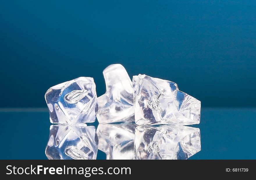 Close-up of ice cubes on blue