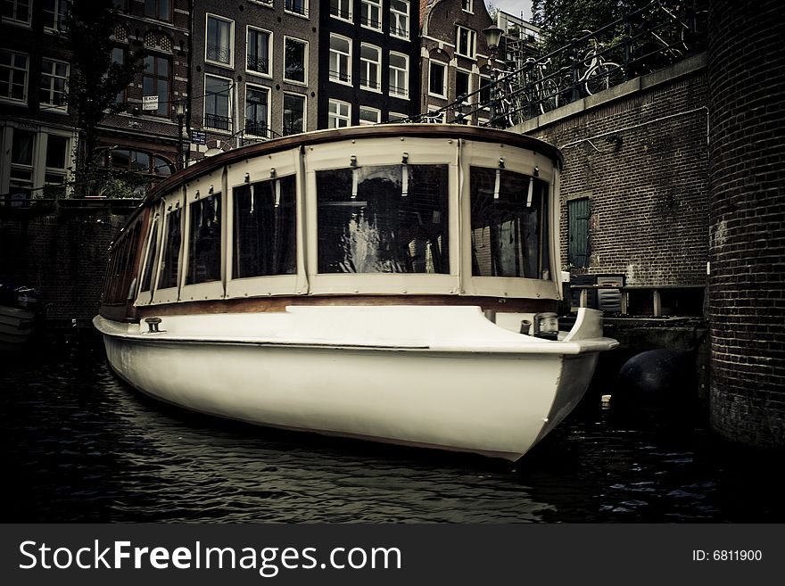 Boat floating in canal in Amsterdam, Holland. Boat floating in canal in Amsterdam, Holland