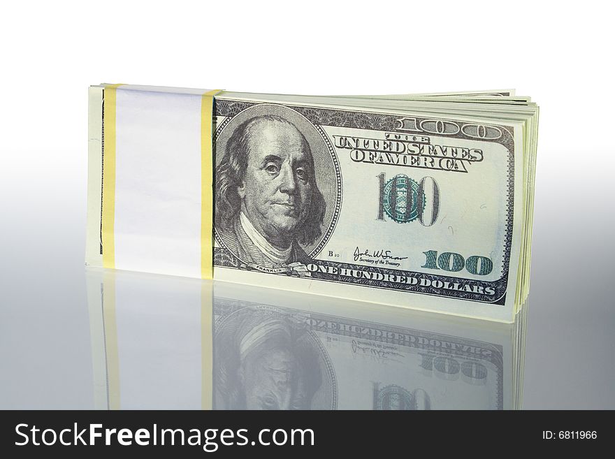 Bundle of dollar's bank notes standing on gray background. Bundle of dollar's bank notes standing on gray background