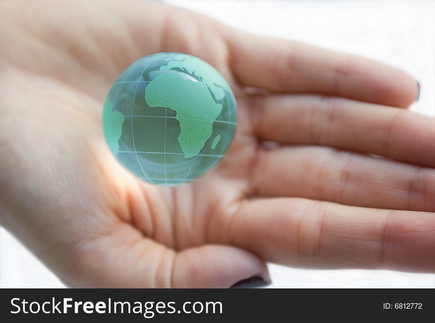 Earth globe (Africa view) in female hands. White