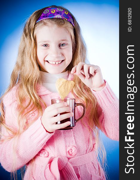 Little girl with tea cup and leaf