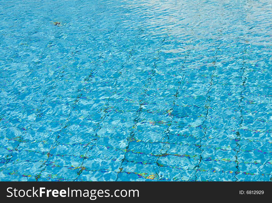 Blue crystal clear swimming pool surface