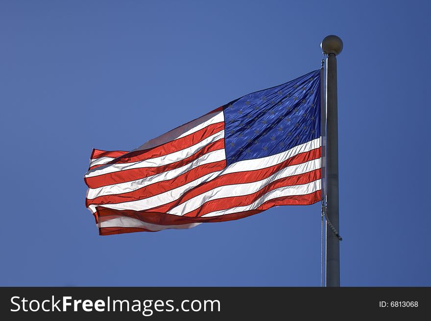 USA flag flutters over blur sky. USA flag flutters over blur sky