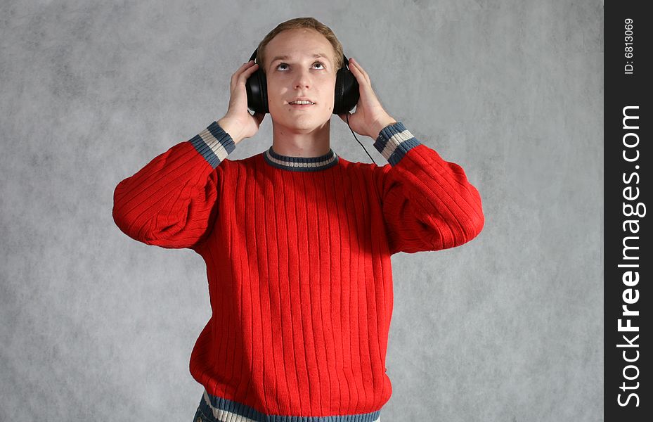 A boy listening music in headphones