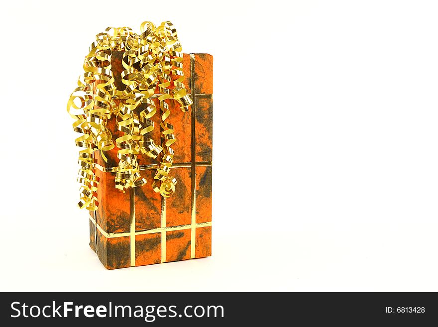 Orange christmas present with golden ties on white background