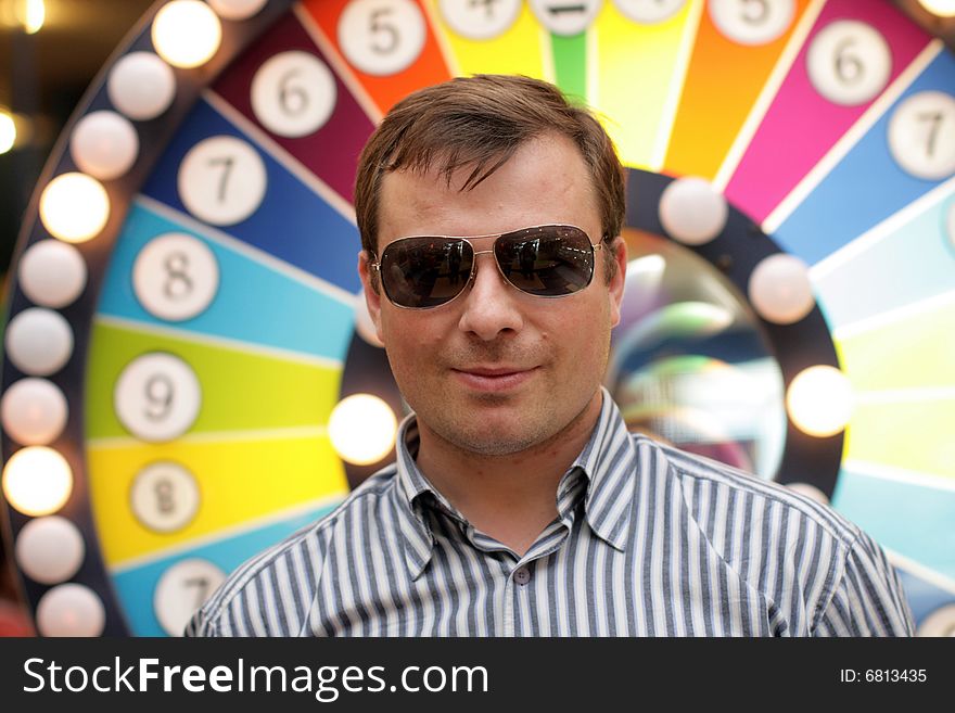 The man in glasses poses in a casino. The man in glasses poses in a casino