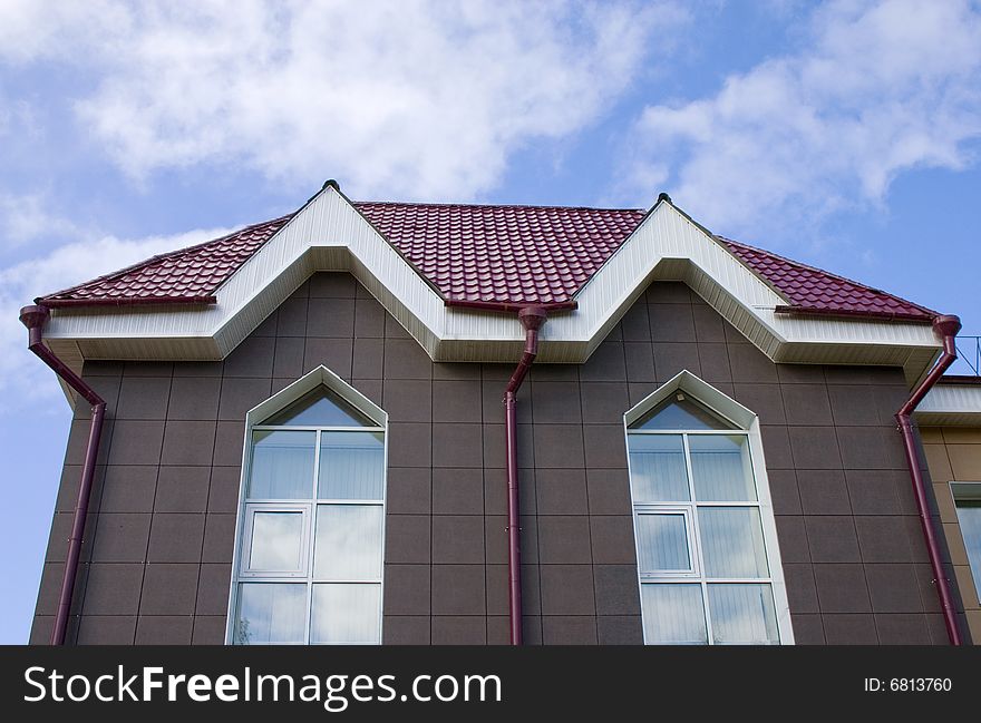 Modern building from a brick. Red tile roof. Modern building from a brick. Red tile roof.