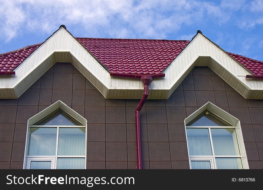 Modern building from a brick. Red roof. A tile. Modern building from a brick. Red roof. A tile.